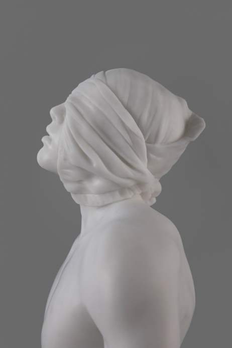 profile view of statue of blindfolded male